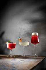 Moody artisan cocktails on weathered industrial table