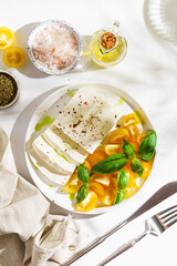 feta cheese with yellow tomatoes and basil