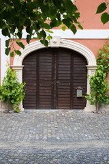 Vintage wooden gate with vine-covered arch
