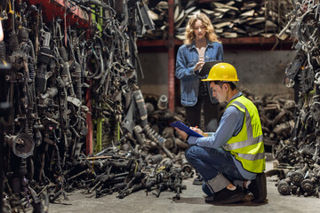 Technician male worker working in garage scrap yard old car part workshop warehouse