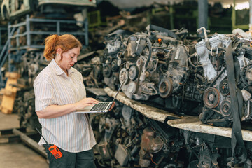 Technician adult women worker working in heavy industry, warehouse manager in garage scrap yard