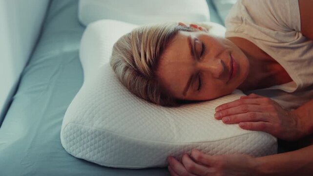 Woman Sleeping Peacefully on Memory Foam Pillow in Bedroom