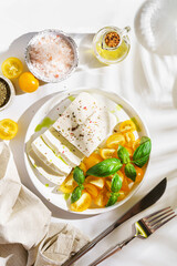 feta cheese with yellow tomatoes and basil