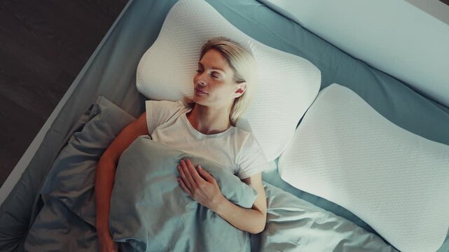 Woman Resting Calmly on Bed with Memory Foam Pillow
