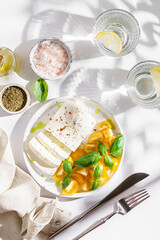 feta cheese with yellow tomatoes and basil