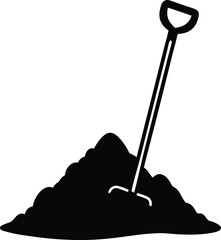 a hoe leaning against a pile of soil