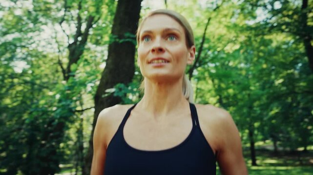 Woman training with resistance band in sunny park