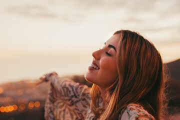 Portrait of one young beautiful woman with opened arms smiling with closed eyes enjoying freedom sensation emotion. Teen cheerful face close up