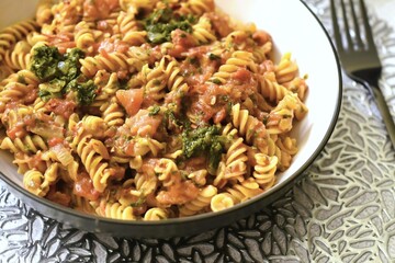 Red lentils fusilli pasta with peeled chopped tomatoes fried onion garlic spinach herbs and crushed dried red chillies.