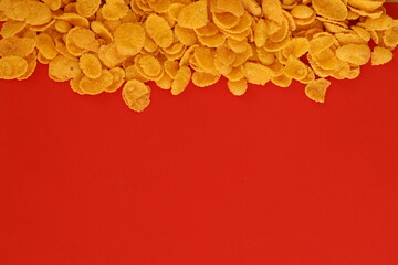 Background of breakfast cereals in big amount on red background, top view