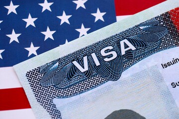 U.S. VISA United States of America. American Tourist or Green Card Visa on flag background © mehaniq41