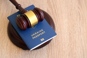 Judge hammer and ukrainian passport on brown background. Passport Of Ukraine