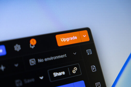 Digital interface displayed on a screen features an Upgrade button, notification icon, and Share option, representing software improvements and premium service subscription opportunities
