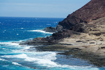 Dramatic cliffs around Montana Bocinegro and Montana Roja mountain, Tenerife coast near El Medano, Canary Islands, Spain, sunny summer day
