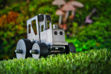 A whimsical macro scene where a toy tractor meets a mushroom forest—blending childhood, fantasy, and industry in a playful visual metaphor. Ideal for themes of creativity, storytelling, and innovation