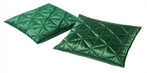 Two emerald green quilted throw pillows on black background cushion jewel tone