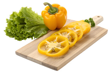 Yellow bell pepper sliced on wooden cutting board with lettuce and parsley sliced bell pepper