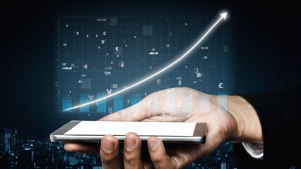 A hand holds a smartphone with a sleek design, showing a digital chart representing financial growth, perfect for illustrating modern investment themes. Copula