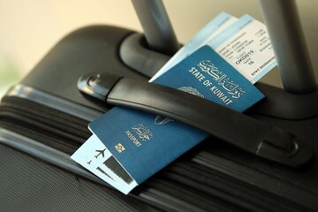 Kuwaiti passport and avia tickets on travel bag. The concept of travel and vacation