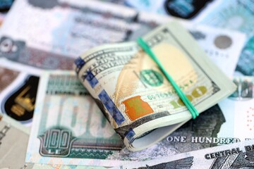 Egyptian pound currency money bills and bunch of us dollars. The concept of currency exchange