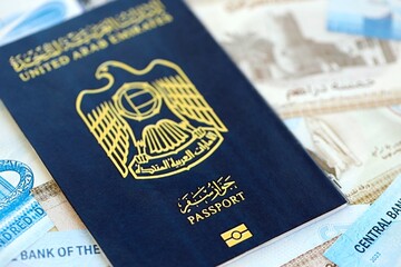 United Arab Emirates dirham currency money bills and passport. The concept of travel and vacation