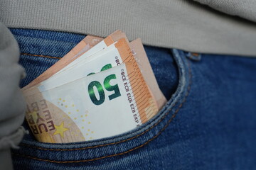 Euro Banknotes Peeking Out of Jeans Pocket