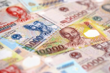 Vietnamese dong currency money bills. The current banknotes lies on table in big amount
