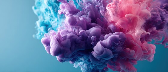 Obraz premium An ethereal cloud of pink, purple, and blue ink gently diffuses through water, creating a mesmerizing and calming abstract design.