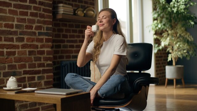 Relaxed Caucasian business woman girl end work closing laptop drinking coffee businesswoman female finish online job done closed computer resting success break meditation relaxation deadline at home