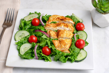 sliced chicken breast on  a salad