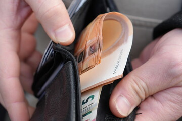 Hands Taking Euro Banknotes Out of a Wallet