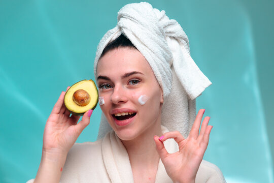 Woman with avocado practicing skincare routine