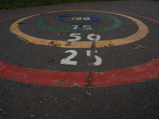 a child game on the asphalt with numbers.jumping.
