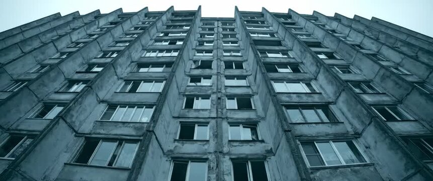 Soviet-style apartment building facade with symmetrical windows and concrete texture