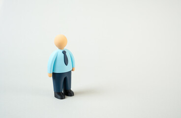 Office worker figurine on a blank background. Space for text. Concept of business template, recruitment design, advertising layout, and career presentation. Symbol of human resources 