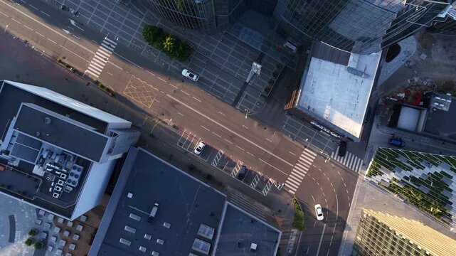 Drone view of modern glass skyscrapers and empty city streets in Vilnius, Lithuania, highlighting urban architecture, business district, and contemporary city design.
