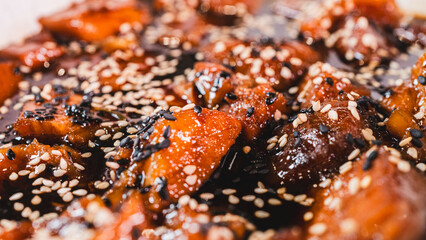 Delicious sticky pork chunks glistening with soy-honey tare glaze. Generously coated in sweet-savory sauce and topped with sesame seeds, served sizzling in an elegant serving dish.