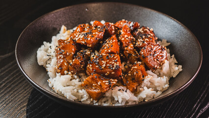A beautiful bowl featuring sticky soy-honey glazed pork over fluffy oriental rice. Topped with sesame seeds and scallions, this delicious bowl combines sweet and savory flavors perfectly.
