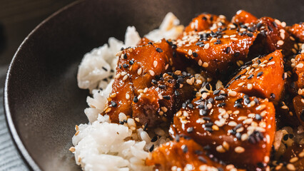 A beautiful bowl featuring sticky soy-honey glazed pork over fluffy oriental rice. Topped with sesame seeds and scallions, this delicious bowl combines sweet and savory flavors perfectly.