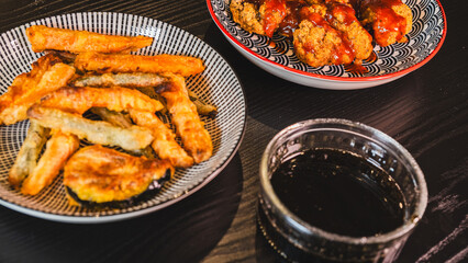 Crispy Korean fried chicken glazed with spicy gochujang sauce, served alongside crunchy vegetable tempura. Accompanied by a delicious sweet soy and honey dipping sauce on the side.