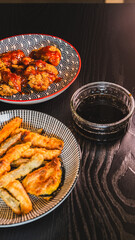 Crispy Korean fried chicken glazed with spicy gochujang sauce, served alongside crunchy vegetable tempura. Accompanied by a delicious sweet soy and honey dipping sauce on the side.