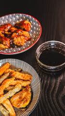 Crispy Korean fried chicken glazed with spicy gochujang sauce, served alongside crunchy vegetable tempura. Accompanied by a delicious sweet soy and honey dipping sauce on the side.