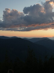 Peaceful night in the mountains — campfire, tents and starry sky