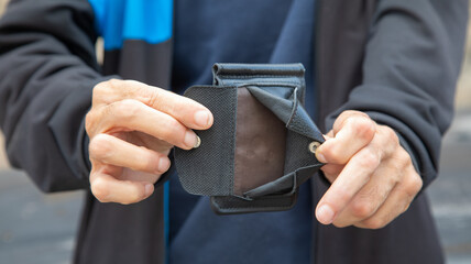 Caucasian young man showing wallet.