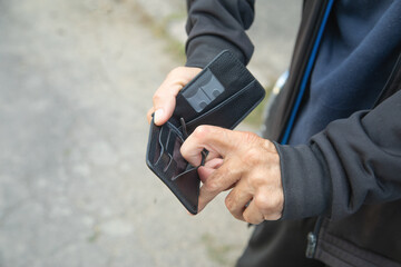 Caucasian young man showing wallet.