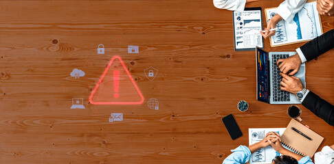 Office meeting scene highlighting a warning symbol on a wooden table, showcasing urgent security...
