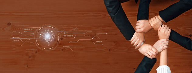 This image features diverse hands joined together over a sleek technology background, representing unity, collaboration, and teamwork in a modern business environment. Trope