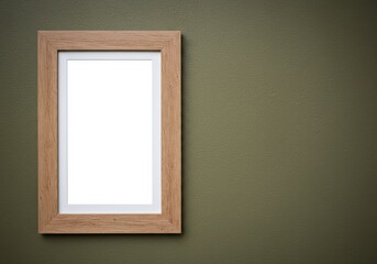 Wooden picture frame with a blank white space hanging on a green wall.