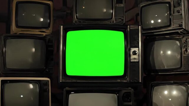 A wall of stacked vintage television sets with one glowing a vibrant chroma key green screen, creating a nostalgic retro media concept