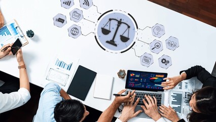 A modern workspace featuring business professionals collaborating, with digital graphics...